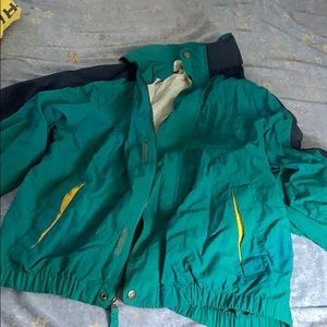 A teal and navy 90s style windbreaker.